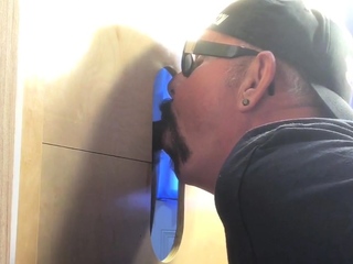 Gloryhole hunk eagerly sucking bbc dick by way of wall