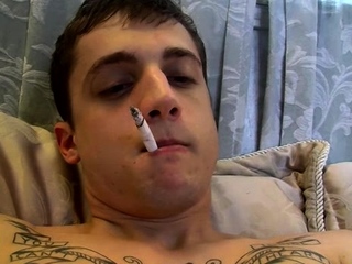 Naughty gay chap cannot stop smoking while teasing his rod