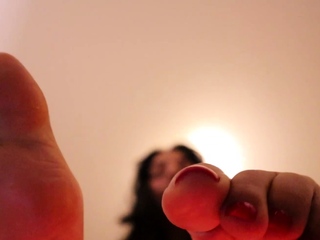 Brunette with foot fetish rubs big dick with her feet in POV