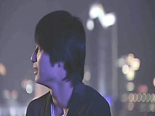 Bai Ling making out with a guy as he opens her red shirt to