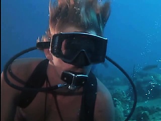 Jacqueline Bisset scuba diving in a white t-shirt that