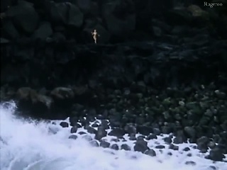 Monique Gabrielle naked seen on a rocky cliff above the