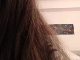 Sexy redheaded Asian girl poses on live cam and gets undres