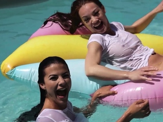 Lesbian girlfriends having fun at a pool