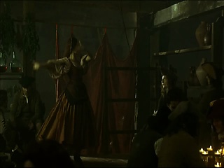 Natalie Portman lying naked on her side on some hay on the