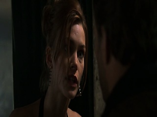 Natasha Henstridge making out with a guy in a bathroom as