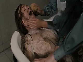 Keira Knightley bent over the arm of a sofa with her top