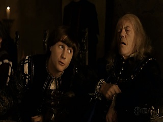 Emmanuelle Chriqui on her back underneath a guy as they