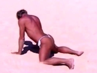 Tanned guy on beach in tiny string thong (temporarily!)