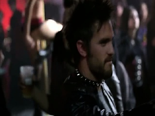 Kelly Overton naked on a chair, arching her back with her