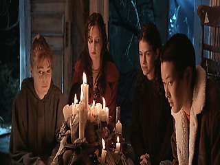 Angelina Jolie pulling her shirt over her head to reveal