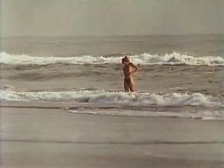 Rosanna Arquette undressing at the beach, ending up in just