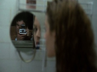 Betsy Russell shown naked through shower glass as she rubs