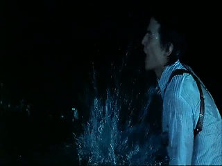 Maggie Q making out with a guy in the ocean and removing