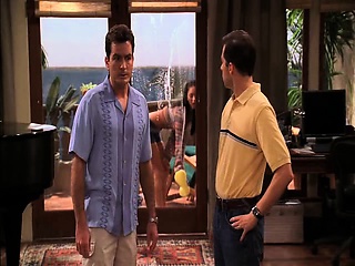 Megan Fox removing her shirt to reveal cleavage in a pink