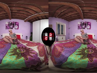 Sexy blonde posing on the bed in short dress