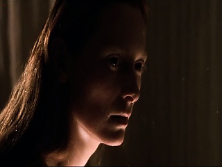 Tilda Swinton naked making out with some guy on the bed.