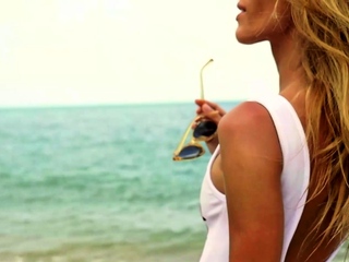 Cute blonde MILF psoing on the beach